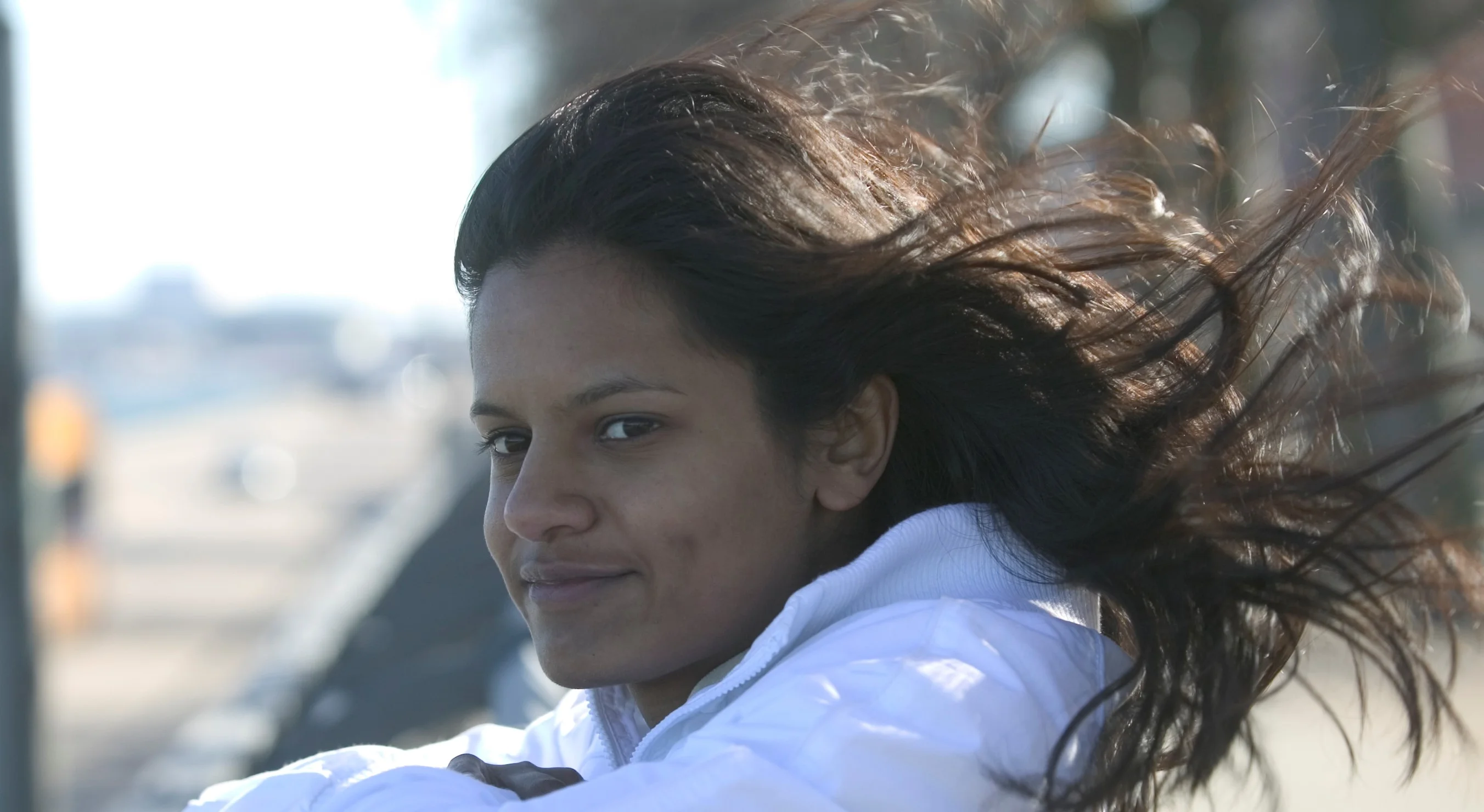 a woman with her hair blowing in the wind